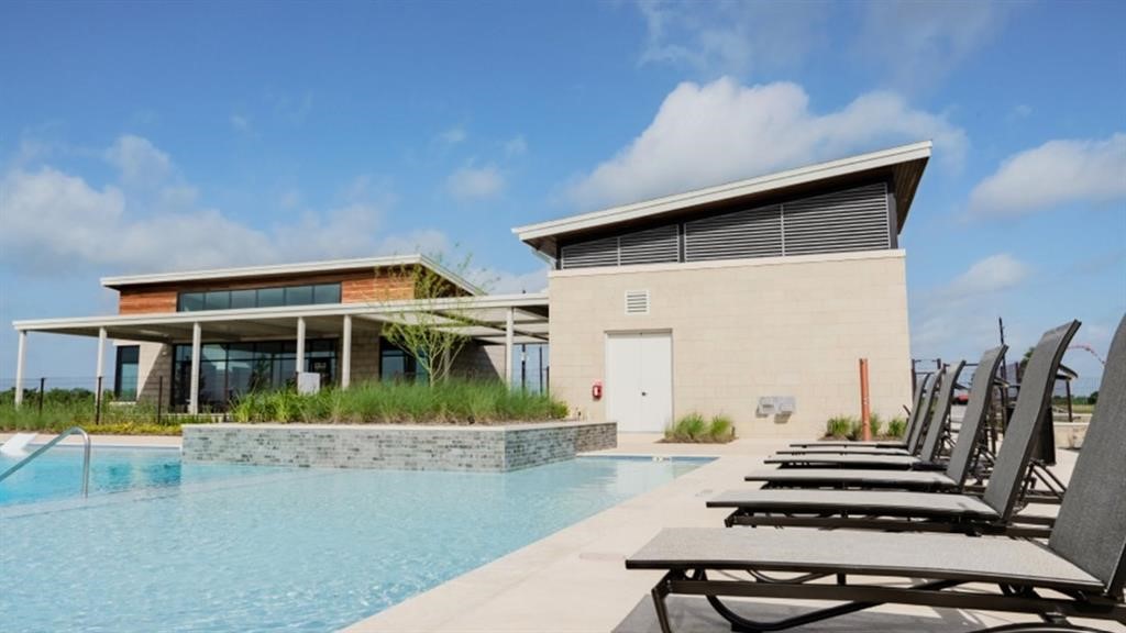 22011 Maddaloni View Drive Hockley, TX 77447 - Photo 5 of 33 a view of a house with large windows and plants
