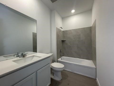 22011 Maddaloni View Drive Hockley, TX 77447 - Photo 10 of 33 a bathroom with a sink a toilet and a large mirror