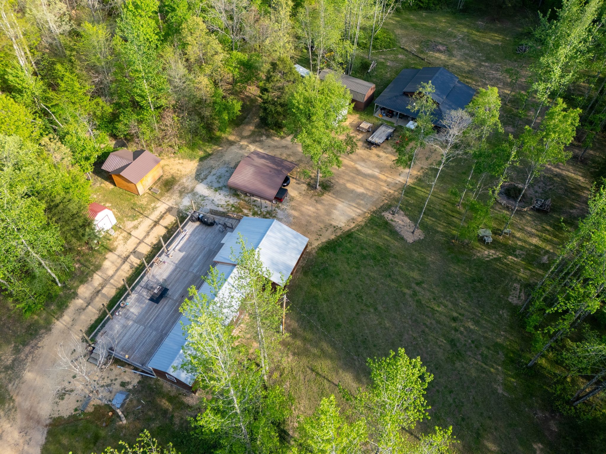 664 Russ Valley Road Lobelville, TN 37097 - Photo 51 of 63 an aerial view of a house with a yard basket ball court and outdoor seating