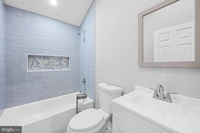 a bathroom with a toilet a sink and bathtub