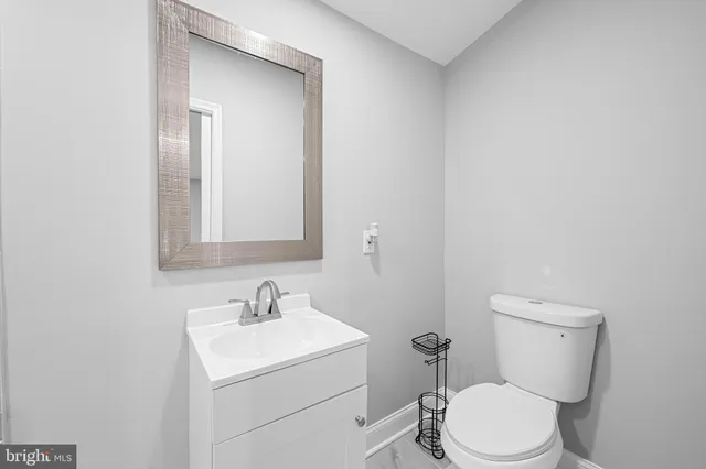 a white toilet sitting next to a bathroom sink