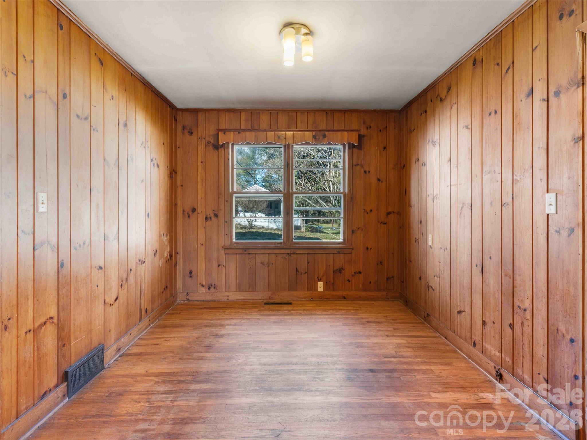 118 Rutledge Drive Hendersonville, NC 28739 - Photo 14 of 48 an empty room with wooden floor and windows
