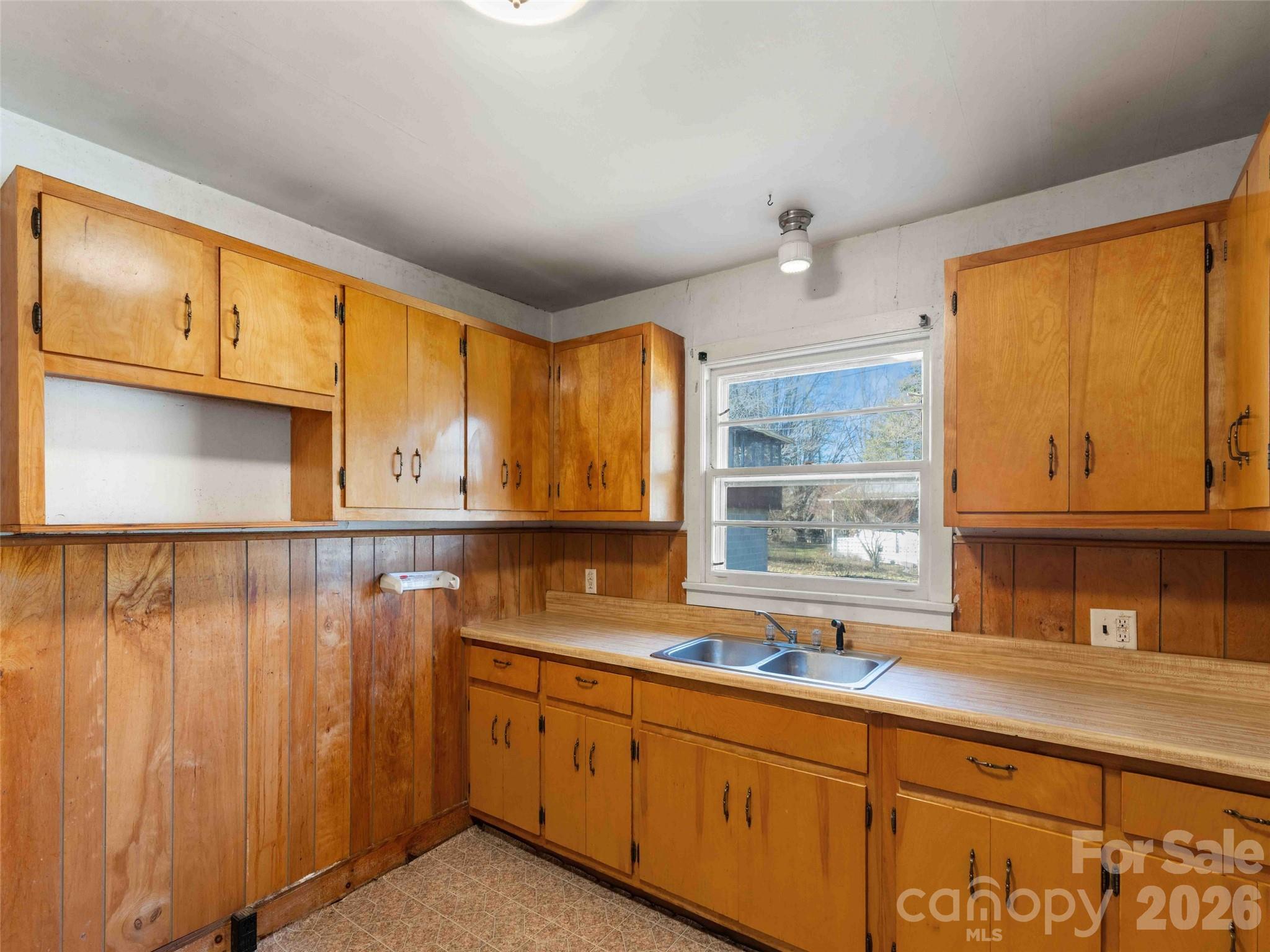 118 Rutledge Drive Hendersonville, NC 28739 - Photo 17 of 48 a kitchen with granite countertop a sink window and cabinets