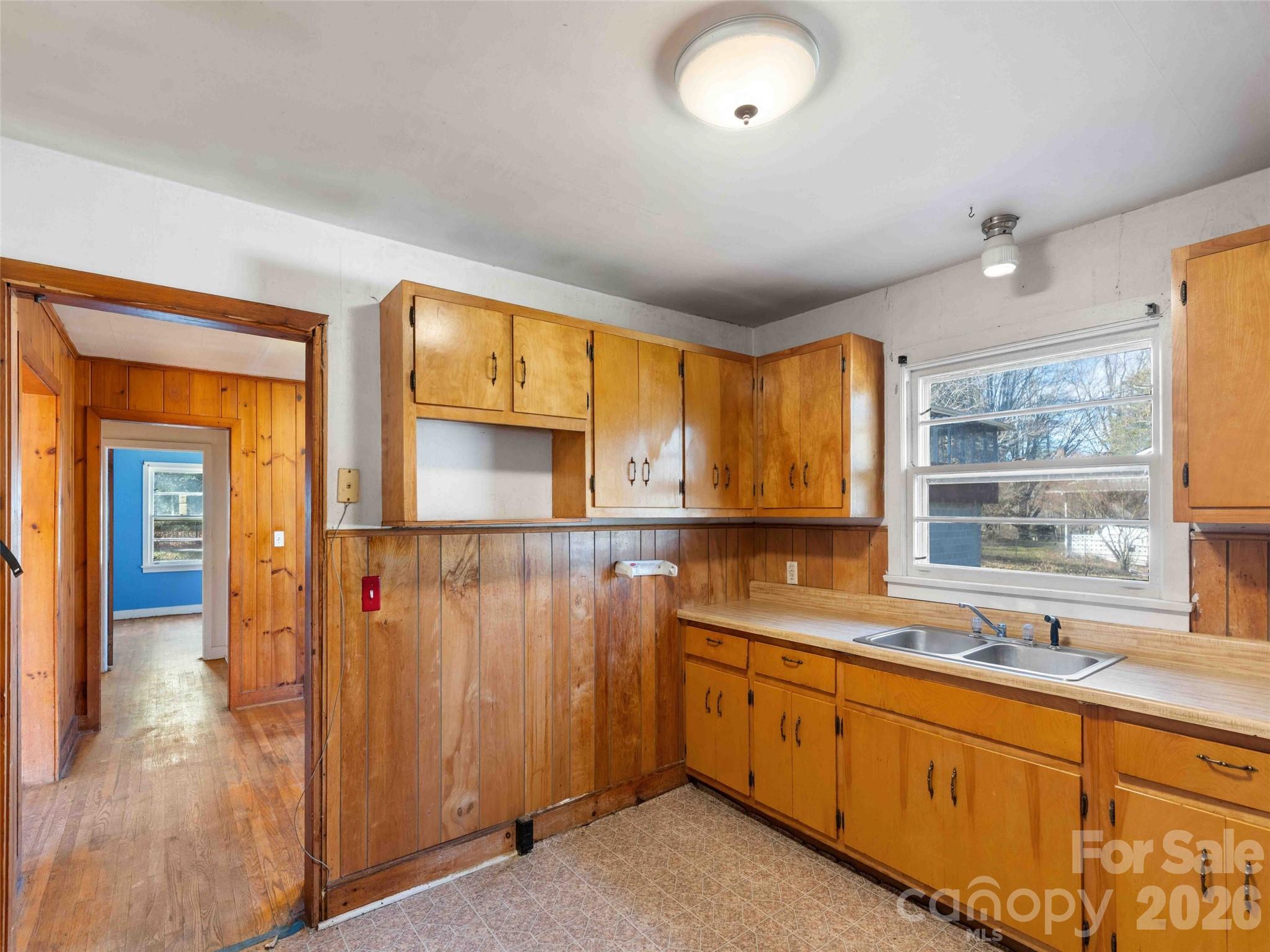 118 Rutledge Drive Hendersonville, NC 28739 - Photo 18 of 48 a kitchen with stainless steel appliances granite countertop a sink and cabinets with wooden floor