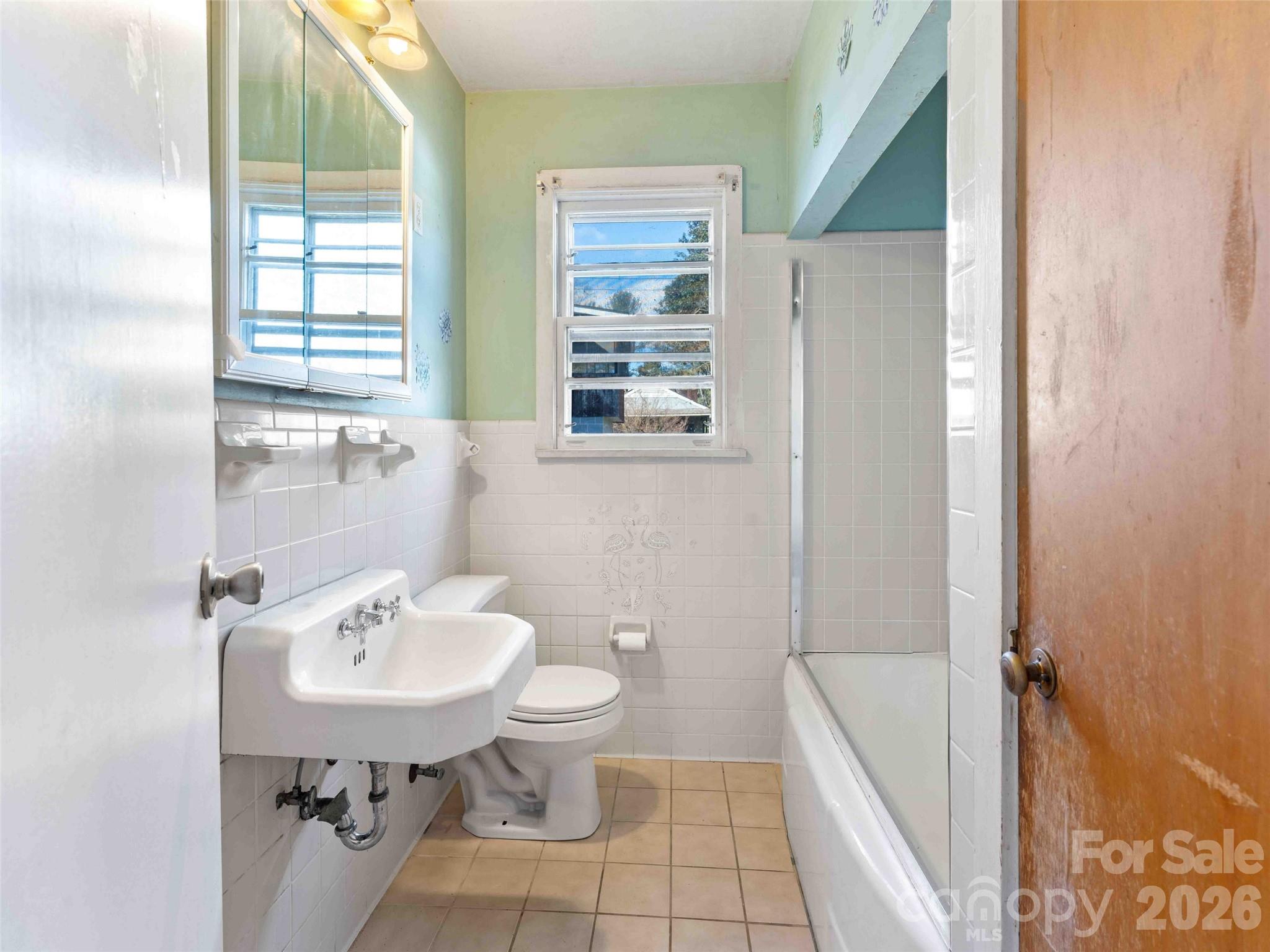 118 Rutledge Drive Hendersonville, NC 28739 - Photo 22 of 48 a bathroom with a sink a toilet and shower