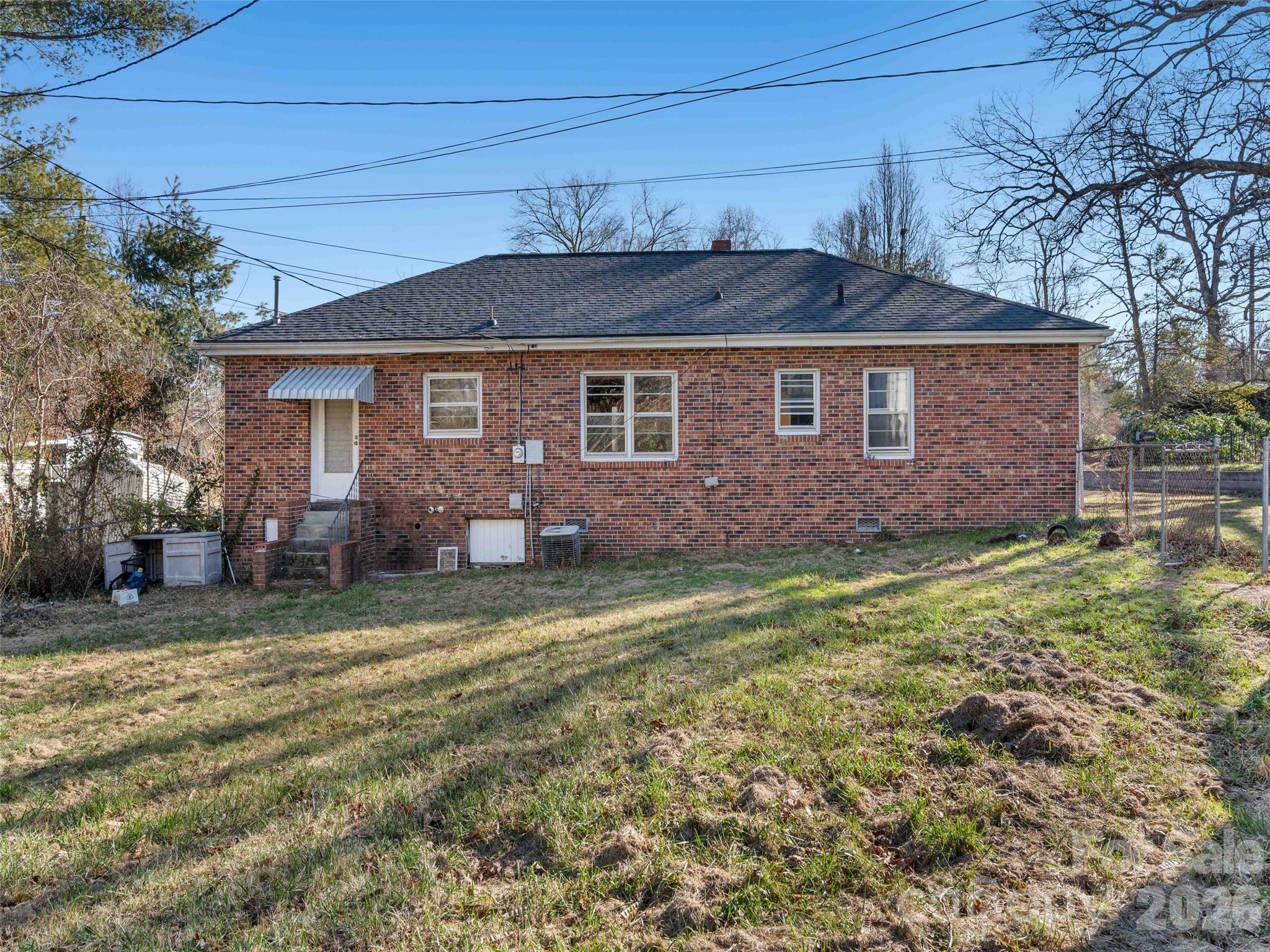118 Rutledge Drive Hendersonville, NC 28739 - Photo 25 of 48 a front view of a house with a garden