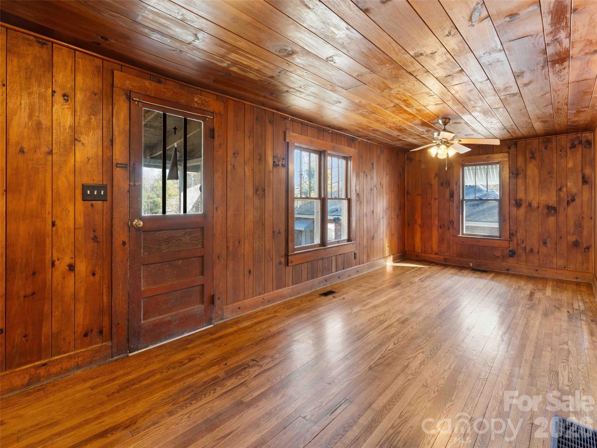 118 Rutledge Drive Hendersonville, NC 28739 - Photo 29 of 48 a view of an empty room with wooden floor and a window