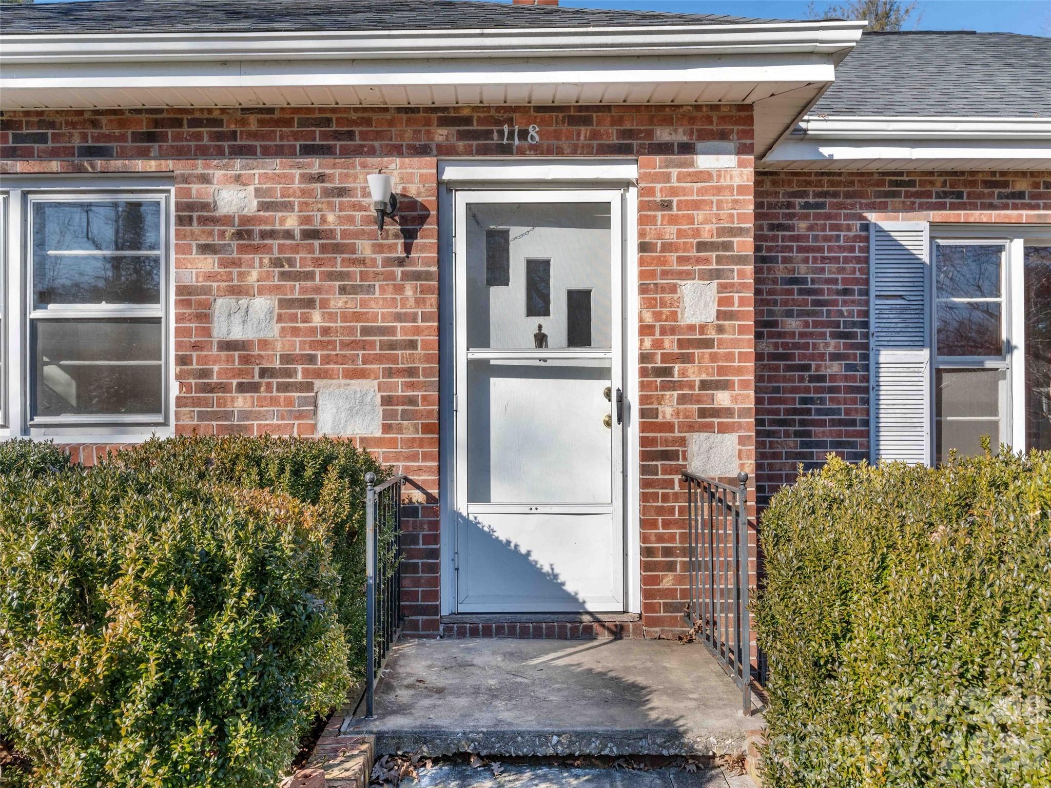 118 Rutledge Drive Hendersonville, NC 28739 - Photo 5 of 48 a front view of a house with a garden