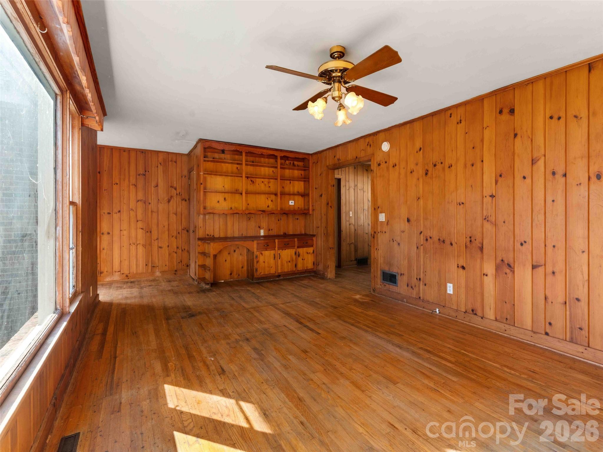 118 Rutledge Drive Hendersonville, NC 28739 - Photo 9 of 48 a view of empty room with wooden floor and fan
