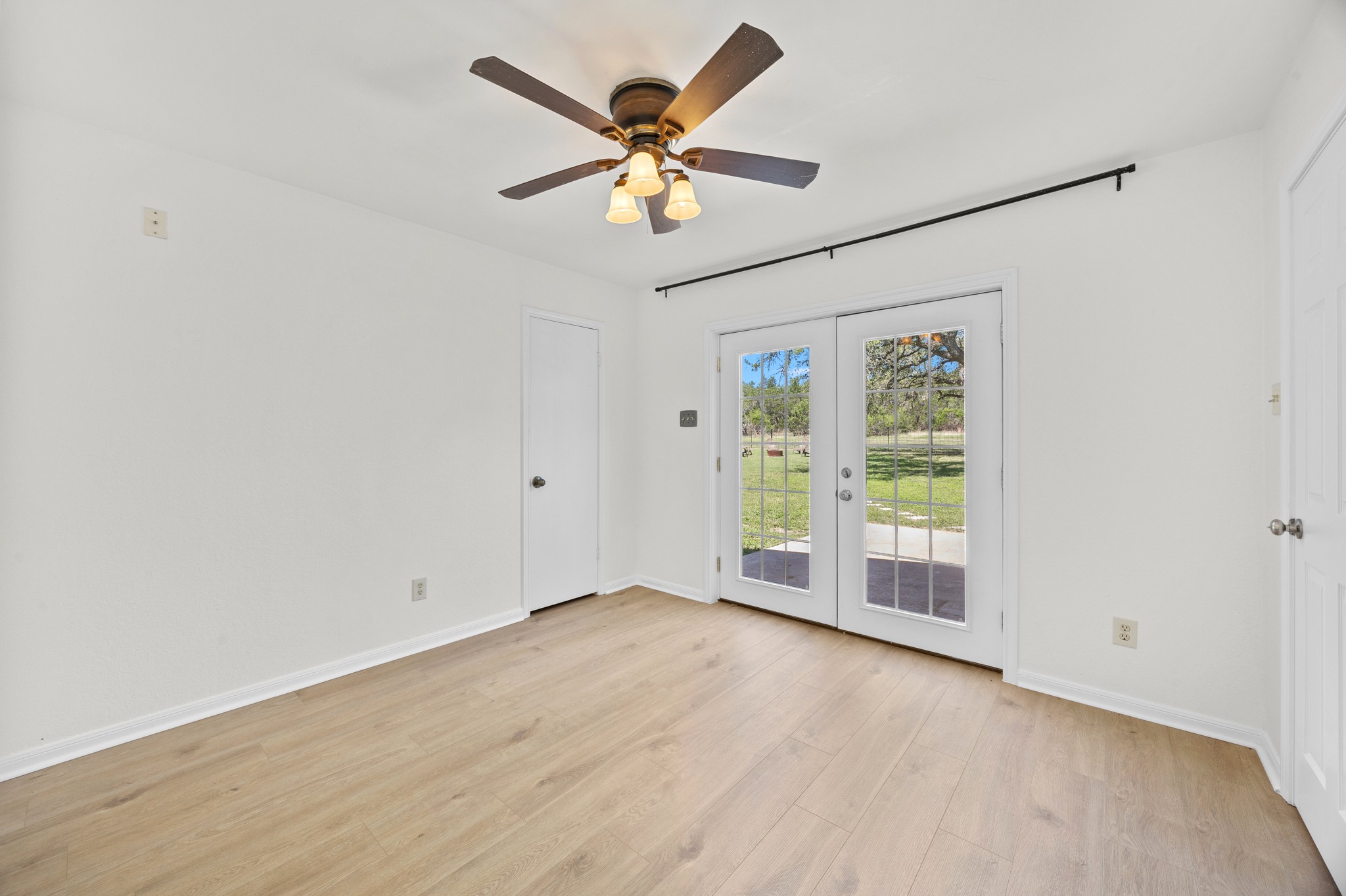 11019 Southwest Oaks Austin, TX 78737 - Photo 23 of 39 Bedroom two offers french door access to the back patio.