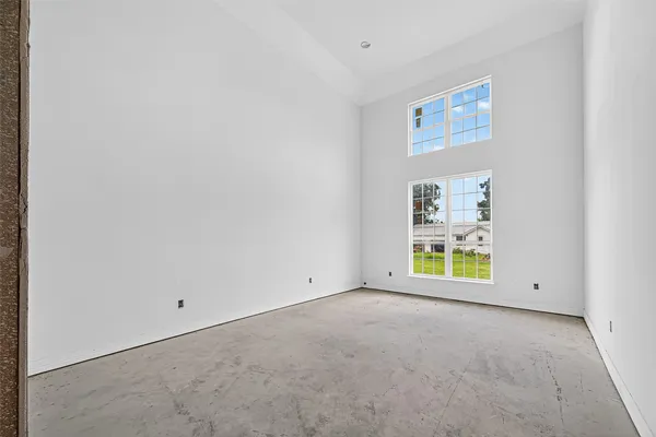 a living room with furniture a fireplace and a large window