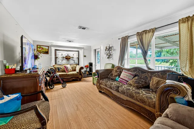 a living room with furniture fireplace and a large window