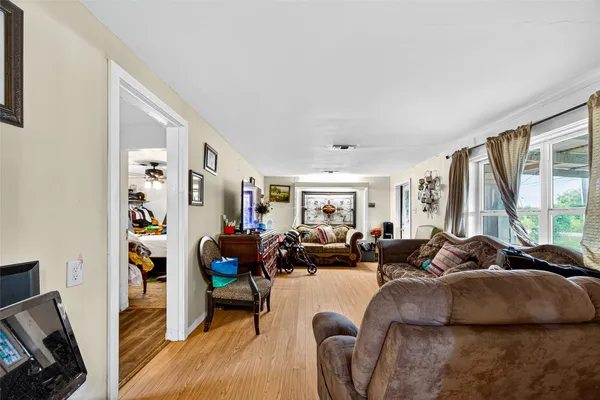 a living room with fireplace furniture and a large window