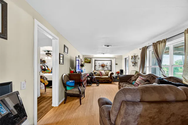 a living room with fireplace furniture and a large window