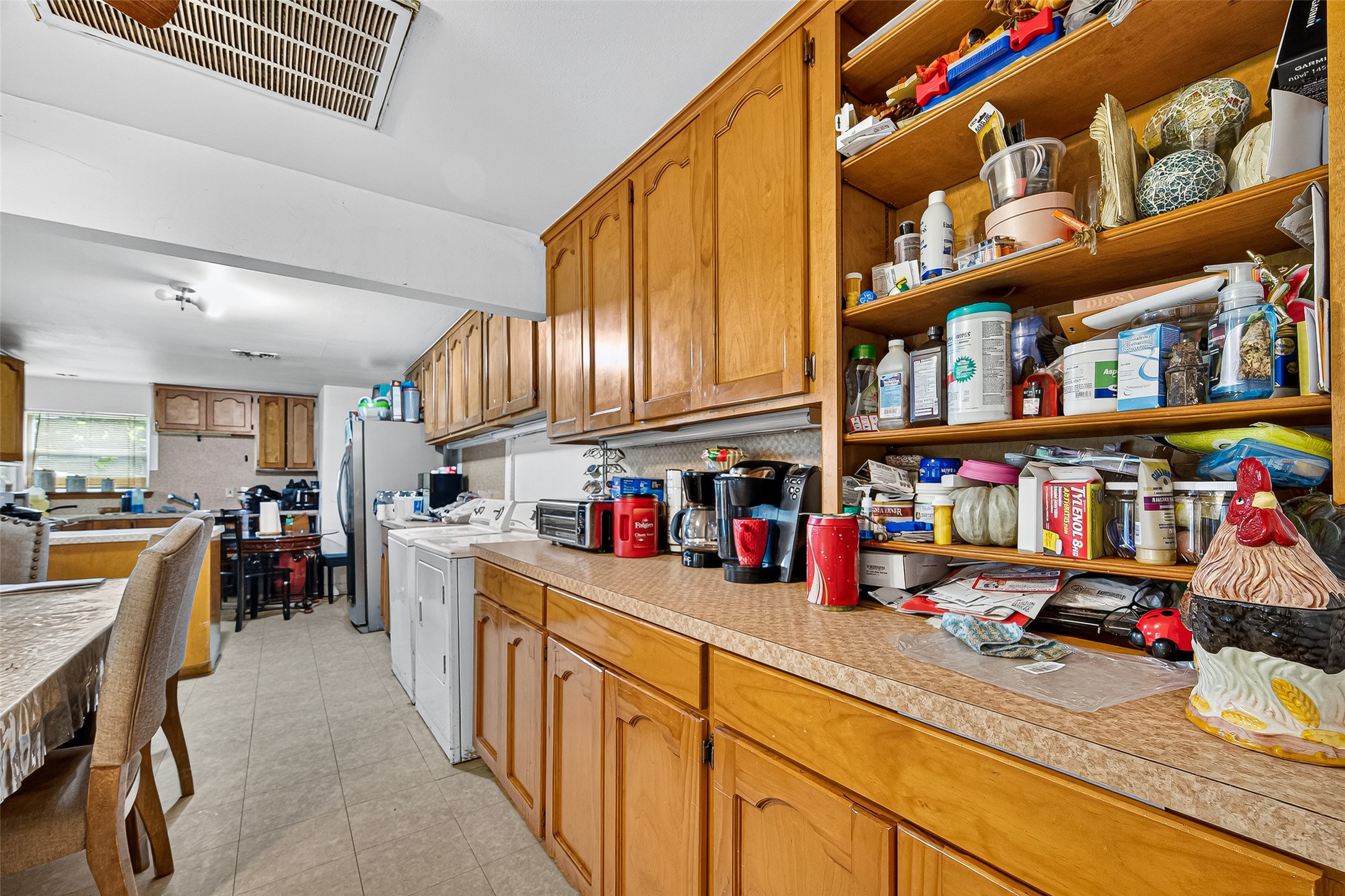 1013 Battlebell Road Highlands, TX 77562 - Photo 37 of 47 a kitchen with lots of clutter and stainless steel appliances