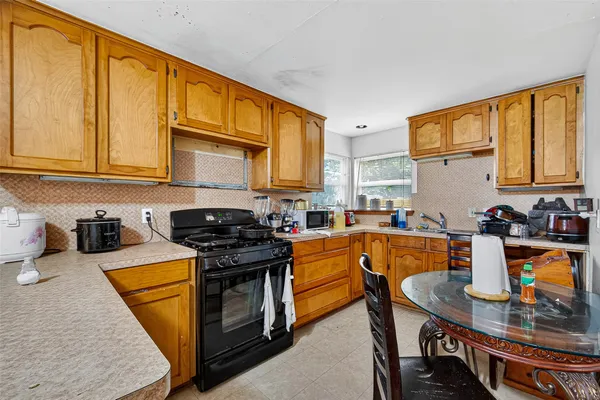 a kitchen with stainless steel appliances granite countertop a sink a stove and a refrigerator