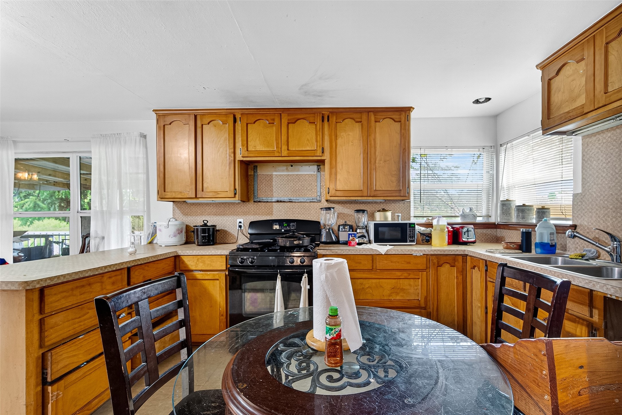 1013 Battlebell Road Highlands, TX 77562 - Photo 41 of 47 a kitchen with stainless steel appliances granite countertop a sink a stove and a refrigerator