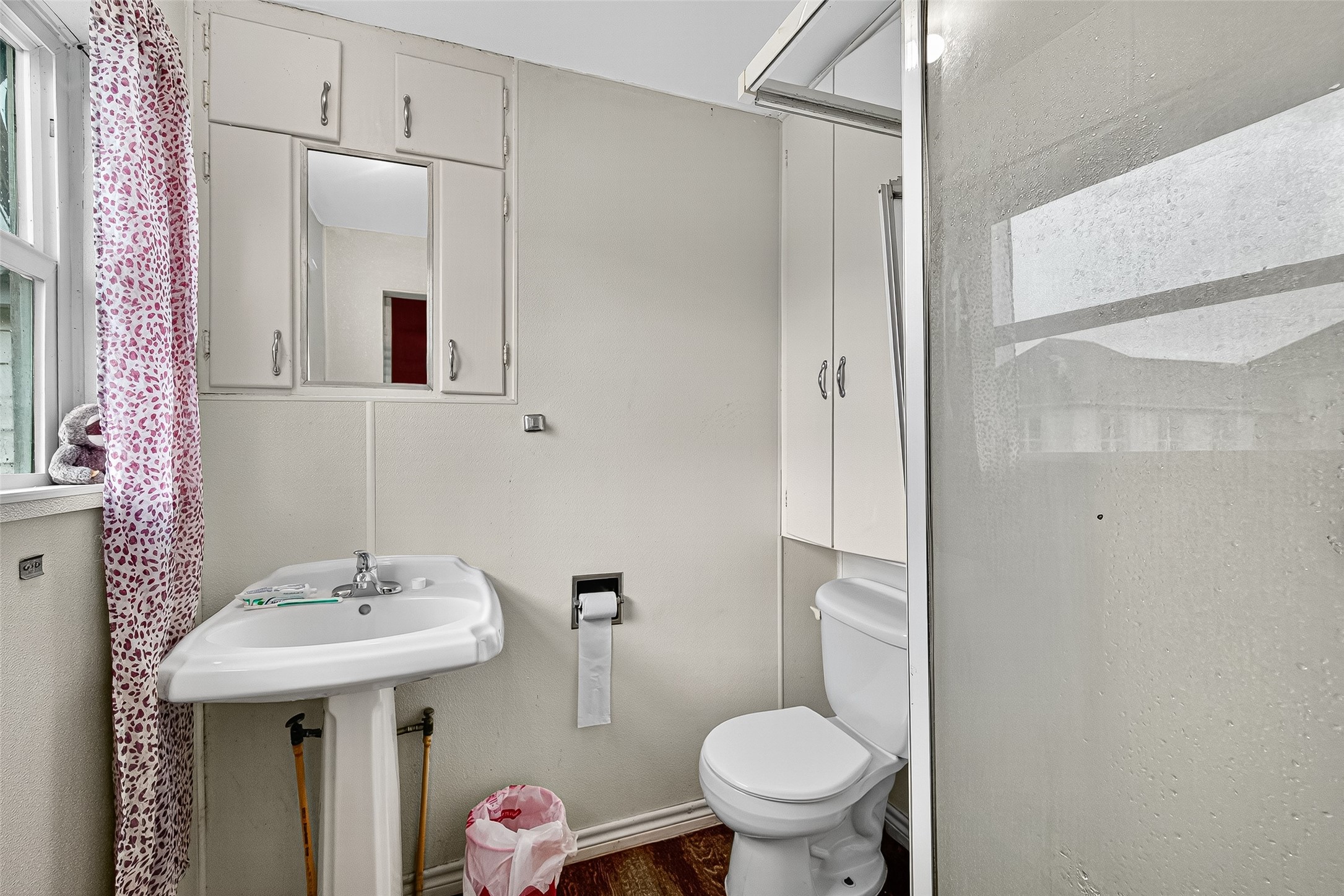 1013 Battlebell Road Highlands, TX 77562 - Photo 42 of 47 a bathroom with a sink toilet and shower