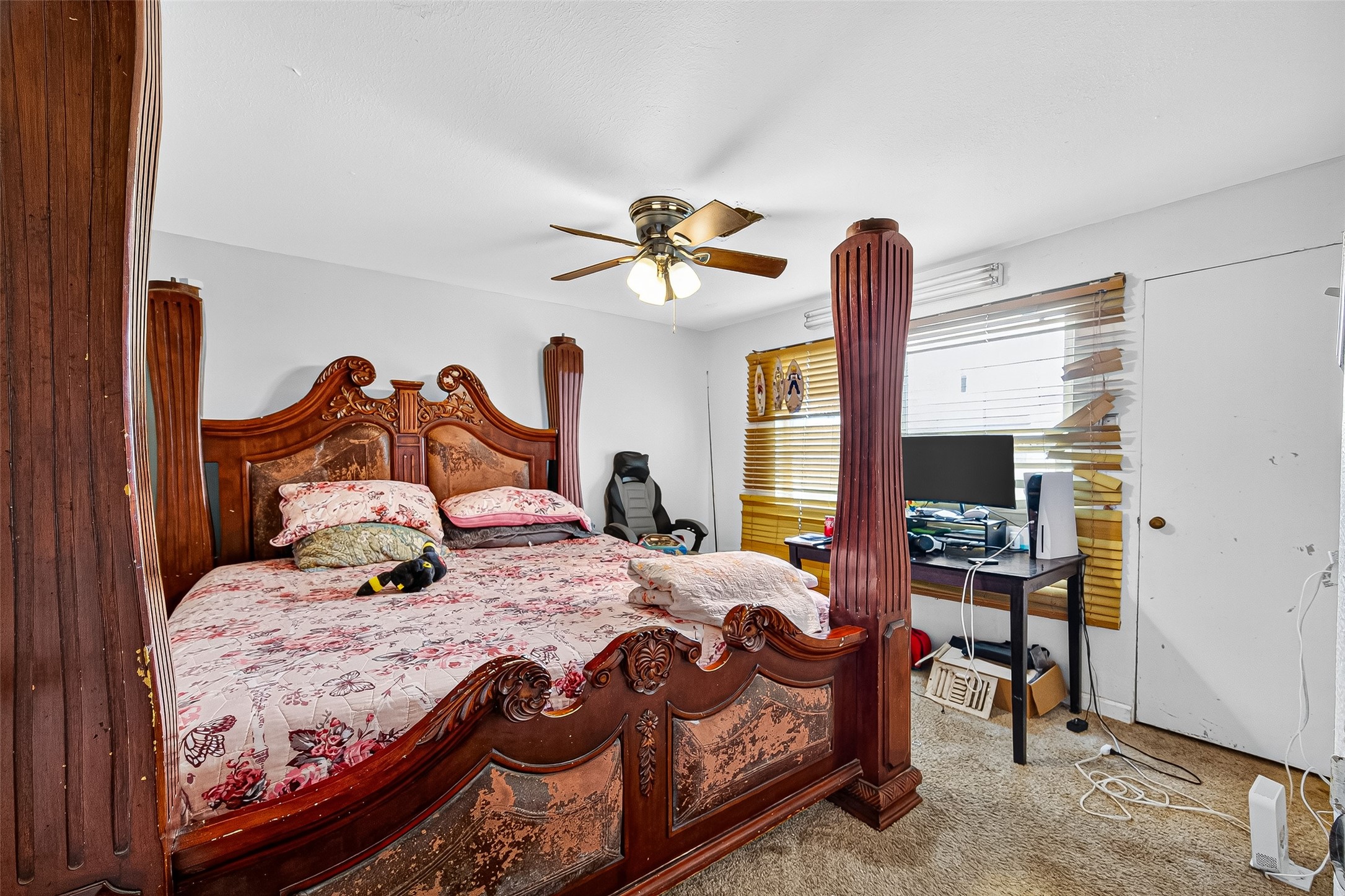 1013 Battlebell Road Highlands, TX 77562 - Photo 43 of 47 a bedroom with a bed and a chandelier