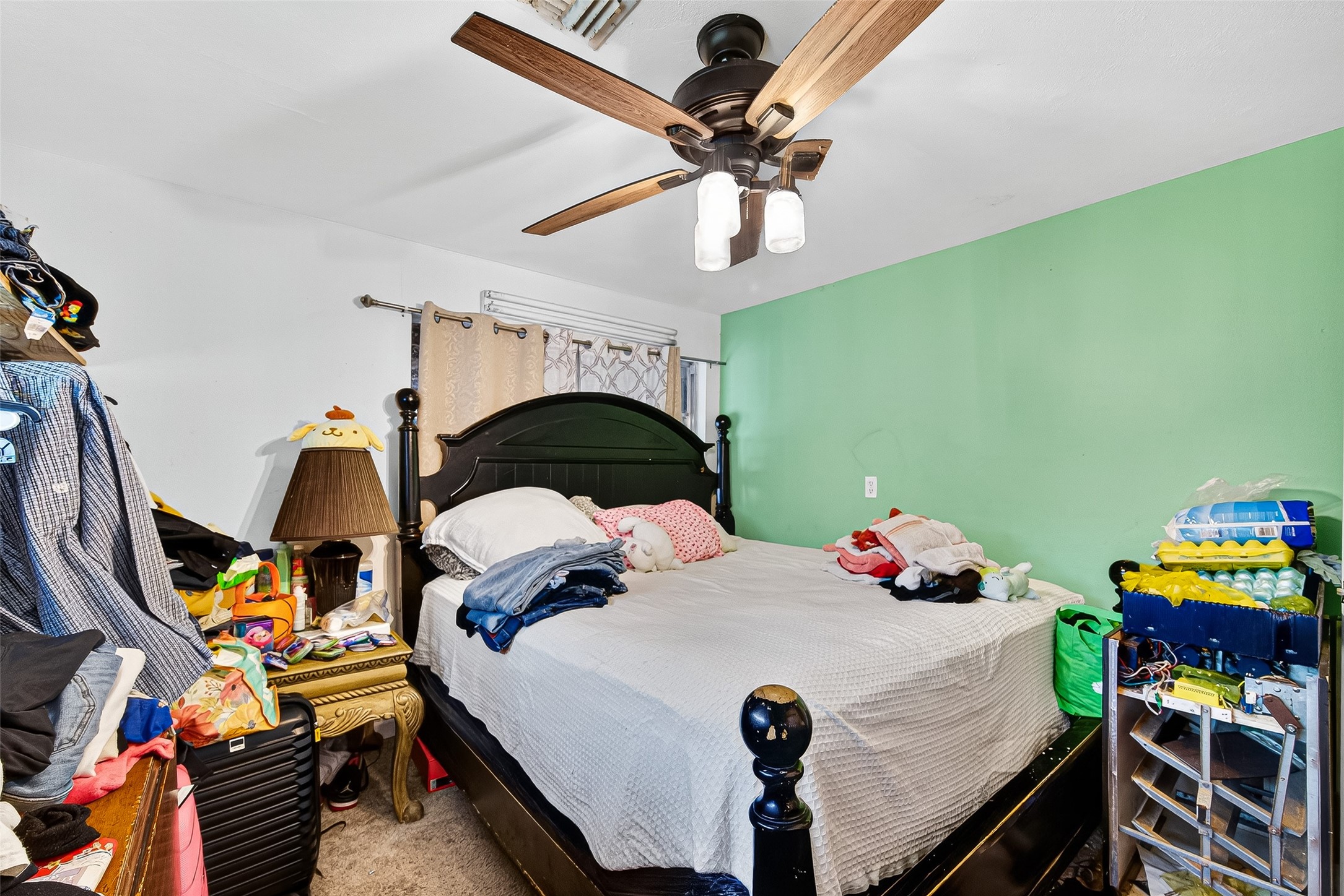 1013 Battlebell Road Highlands, TX 77562 - Photo 45 of 47 a bedroom with a bed and a chandelier