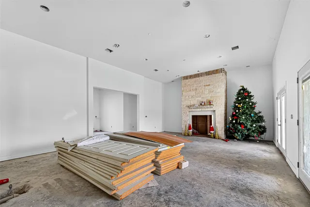 a spacious bedroom with a bed and a fireplace