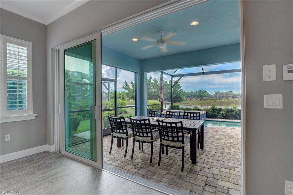 5708 Highbourne Drive Naples, FL 34113 - Photo 11 of 28 a view of a city from a dining room with furniture window and outside view