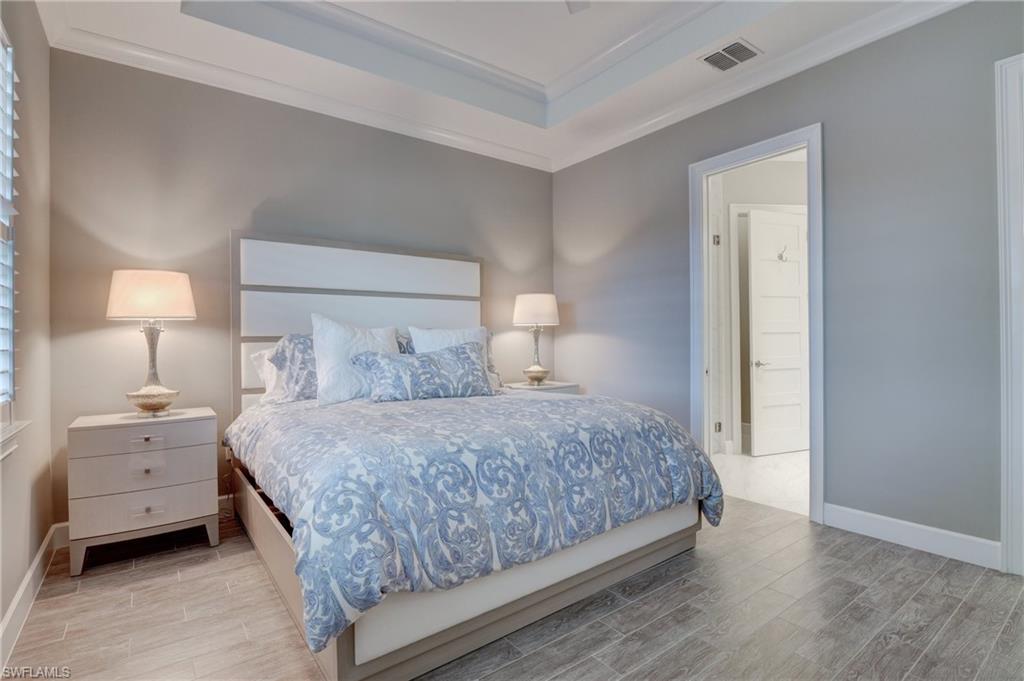 5708 Highbourne Drive Naples, FL 34113 - Photo 14 of 28 a bedroom with a bed and a lamp