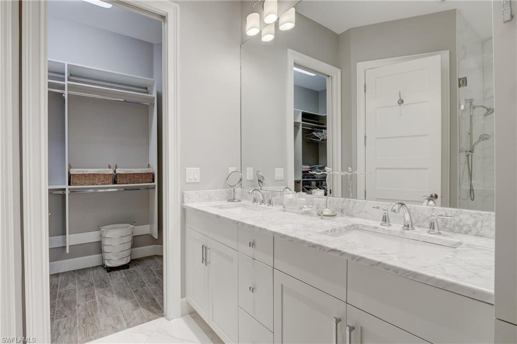 5708 Highbourne Drive Naples, FL 34113 - Photo 15 of 28 a bathroom with a granite countertop sink and a mirror