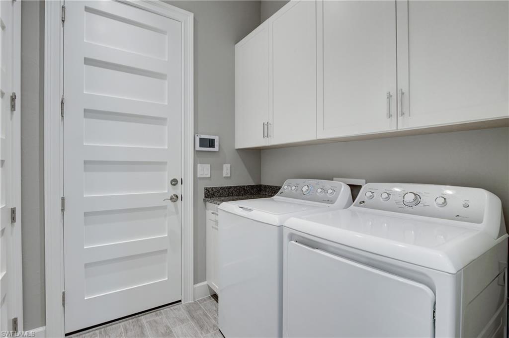 5708 Highbourne Drive Naples, FL 34113 - Photo 19 of 28 a view of storage and utility room with washer and dryer