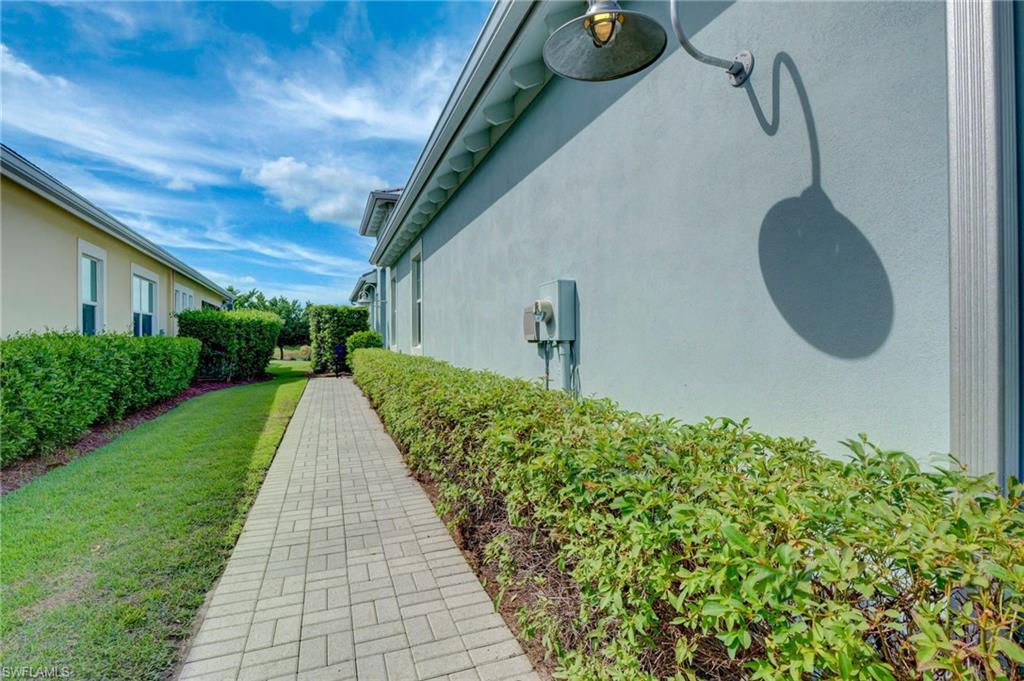 5708 Highbourne Drive Naples, FL 34113 - Photo 20 of 28 a front view of a house with a yard