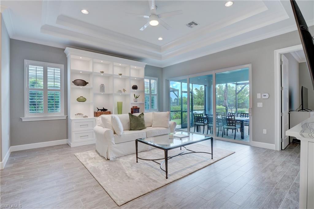 5708 Highbourne Drive Naples, FL 34113 - Photo 3 of 28 a living room with furniture and a floor to ceiling window
