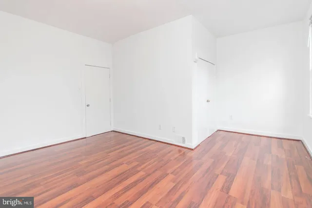 an empty room with wooden floor