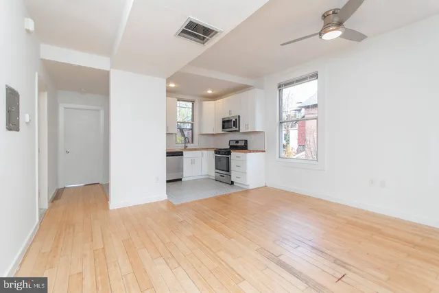 a view of a kitchen with microwave and cabinets