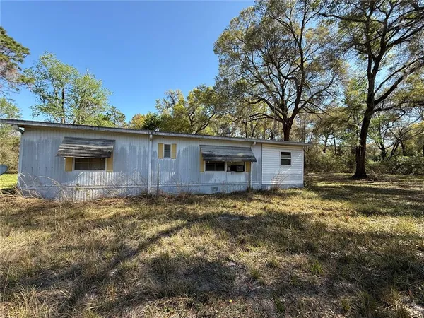 a backyard of a house with large trees