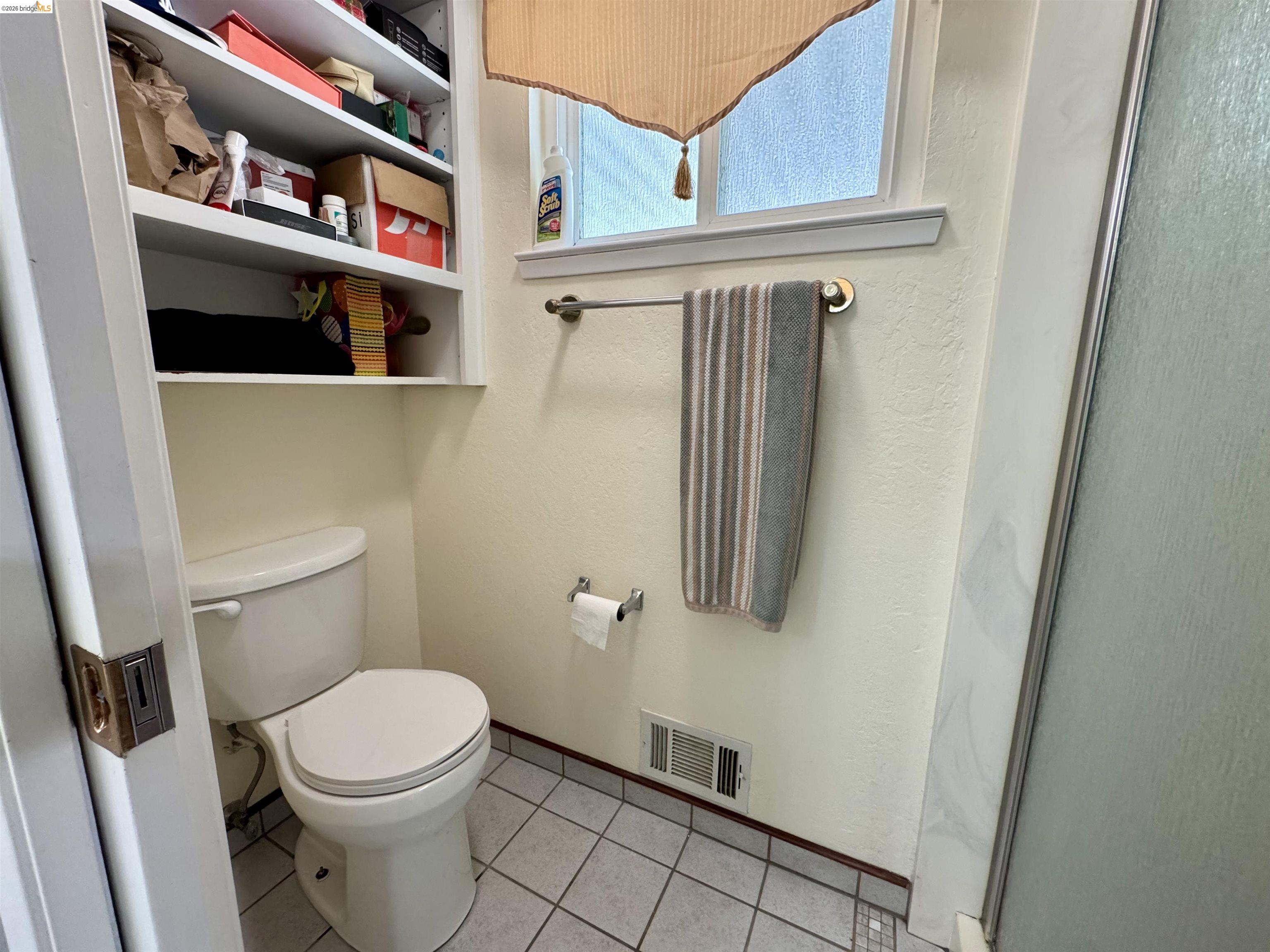 3513 Rio Grande Drive Antioch, CA 94509 - Photo 17 of 22 Built-in shelving over a white toilet, set against textured cream walls