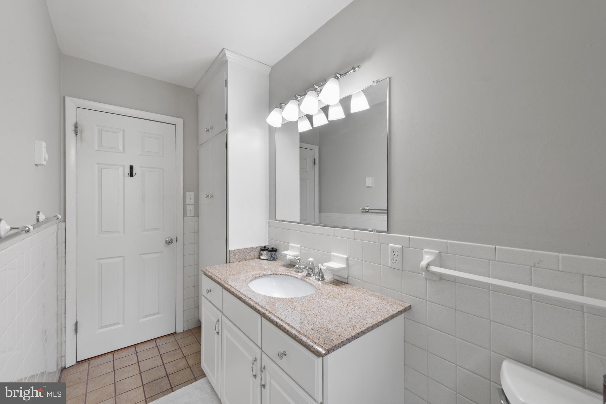 3242 Lineboro Road Manchester, MD 21102 - Photo 19 of 30 a bathroom with a granite countertop sink a toilet and a mirror