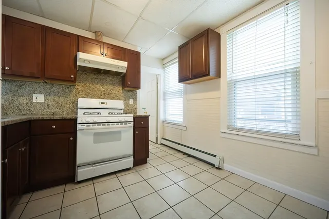 a kitchen with a stove cabinets and a refrigerator