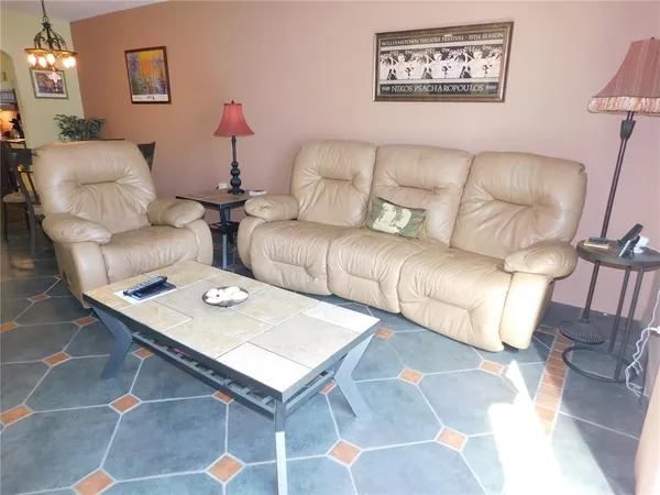 a living room with furniture and potted plant