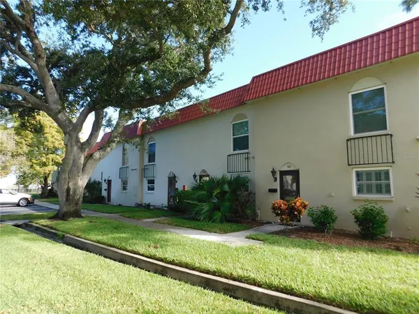 a view of a house with backyard and sitting area
