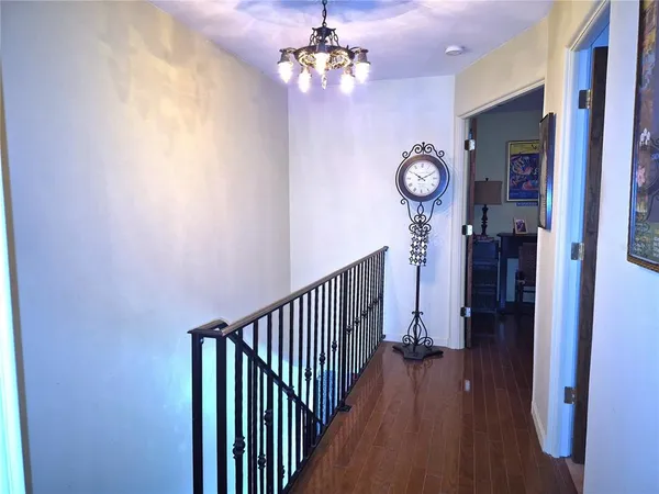 a bedroom with a bed and a flat tv screen on the dresser