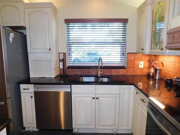 a kitchen with granite countertop a sink and a window