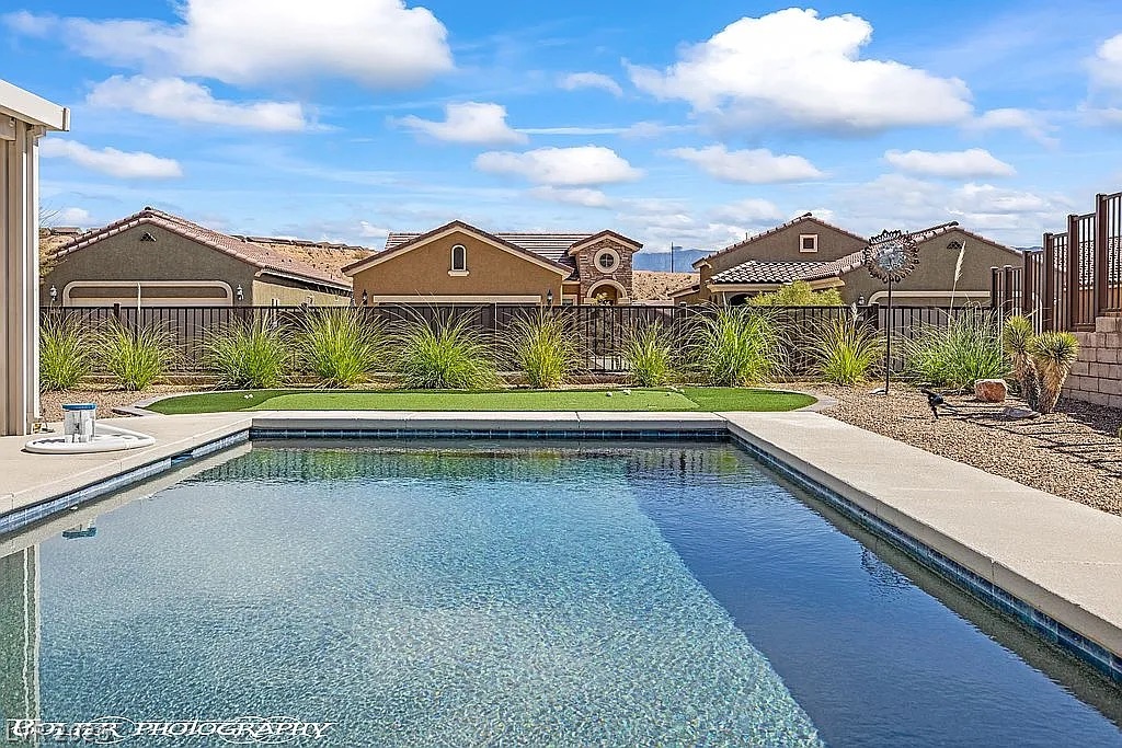 1304 Cottage Ridge Mesquite, NV 89034 - Photo 5 of 52 A refreshing pool awaits in this desert oasis, complemented by a private putting green.