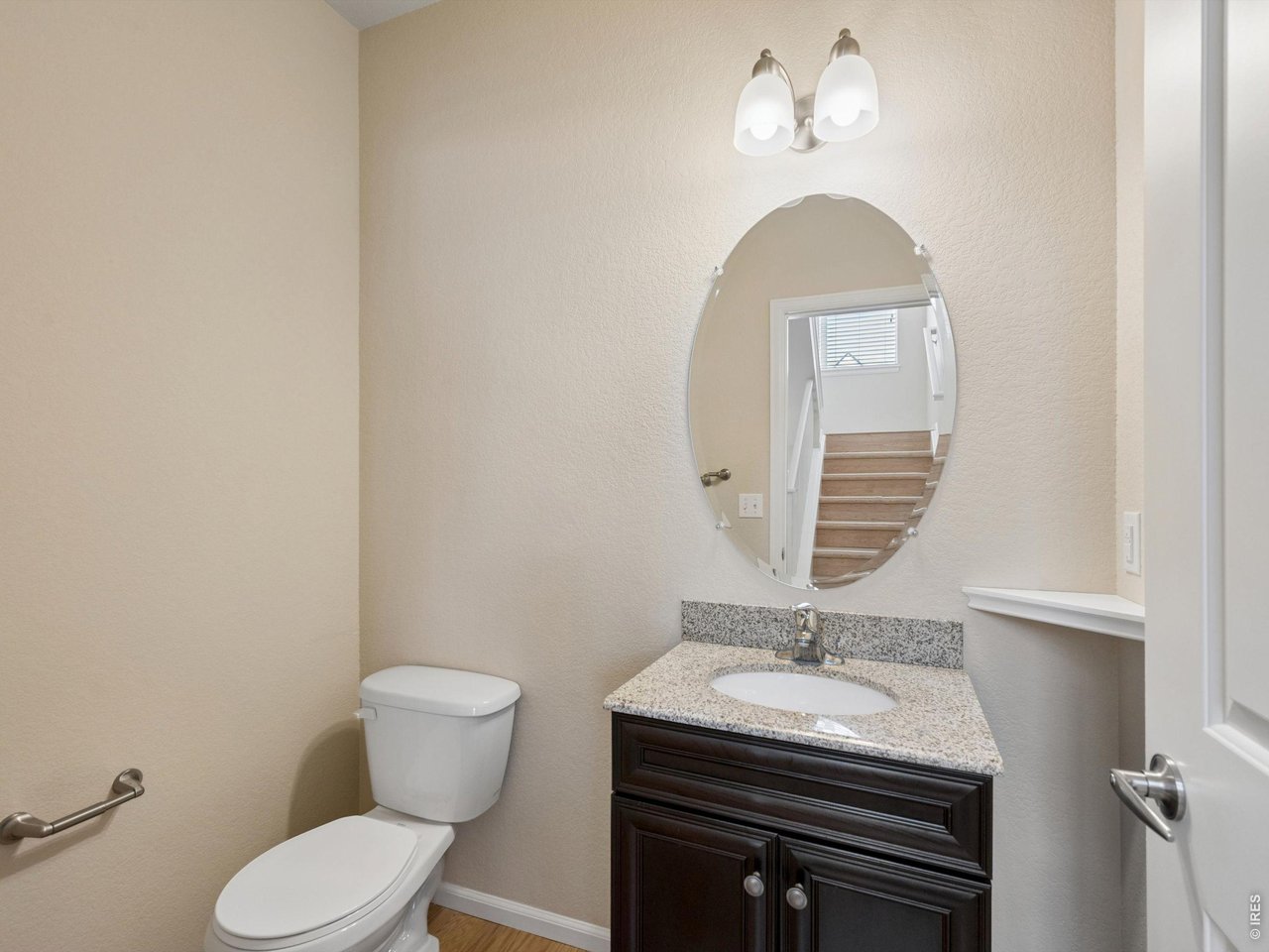 11202 Colony Circle Broomfield, CO 80021 - Photo 9 of 23 a bathroom with a granite countertop toilet a sink and a mirror