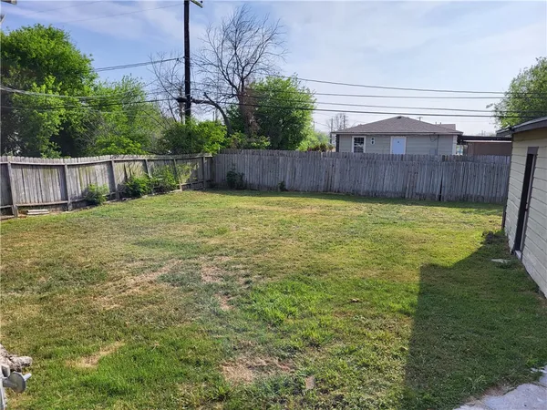 a view of a field with wooden fence