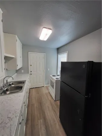 a kitchen with a refrigerator and a sink
