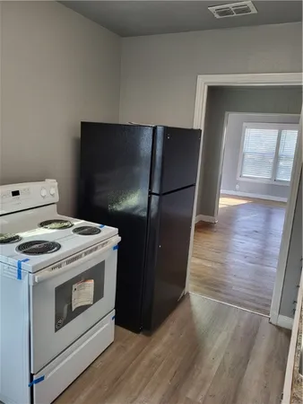 a kitchen with a stove and a refrigerator