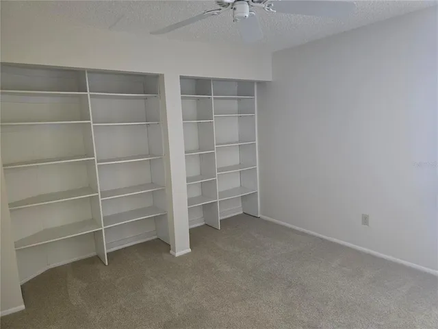 a view of an empty room with empty shelves