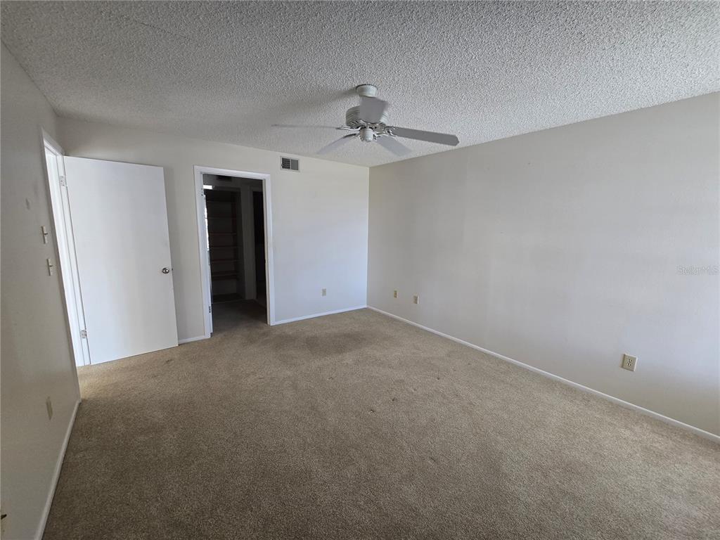 411 South Bayshore Boulevard, Unit 1 Safety Harbor, FL 34695 - Photo 23 of 30 a view of a room with a ceiling fan and carpet