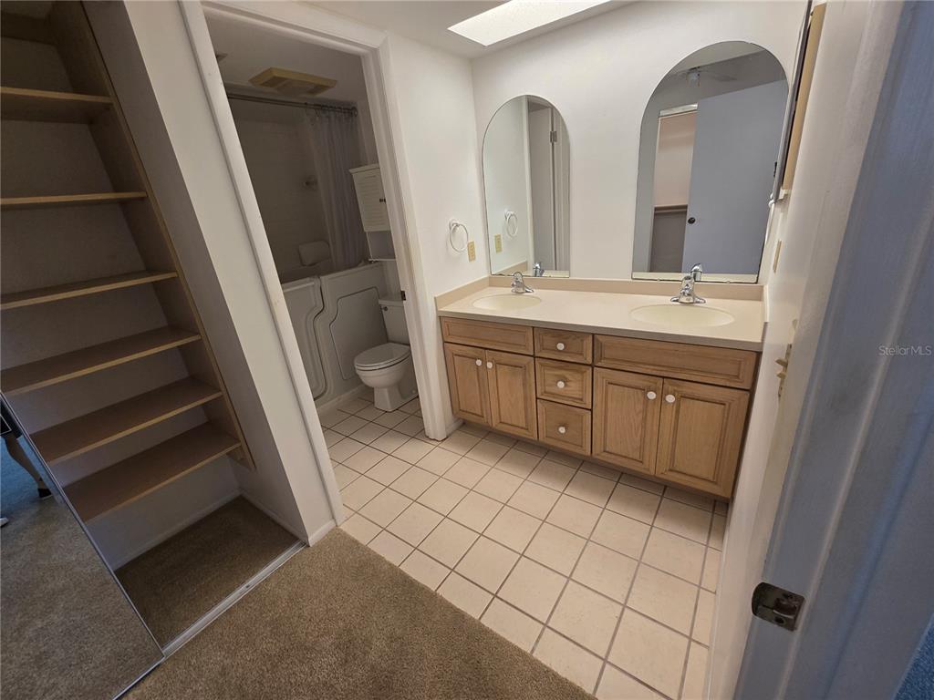 411 South Bayshore Boulevard, Unit 1 Safety Harbor, FL 34695 - Photo 25 of 30 a bathroom with a double vanity sink and mirror