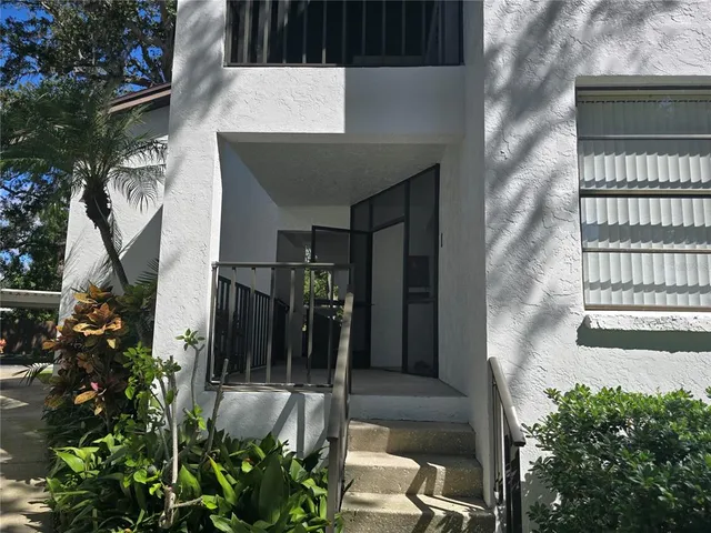 a house with potted plants in front of door